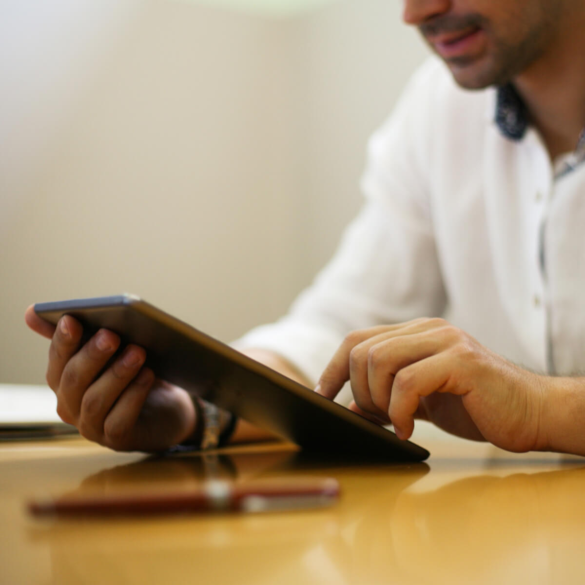 man-tapping-ipad-sq